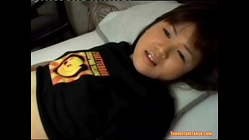 An Asian girl is laying on her back on a bed, stroki from http://alljapanese.net