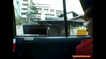 An Asian girl is sitting in the back of a taxi. She  from http://alljapanese.net